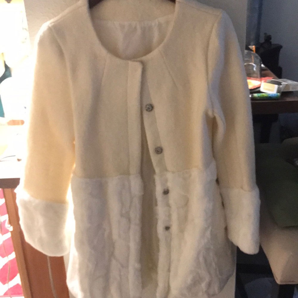A cream colored 3/4 coat with fake fur on it
